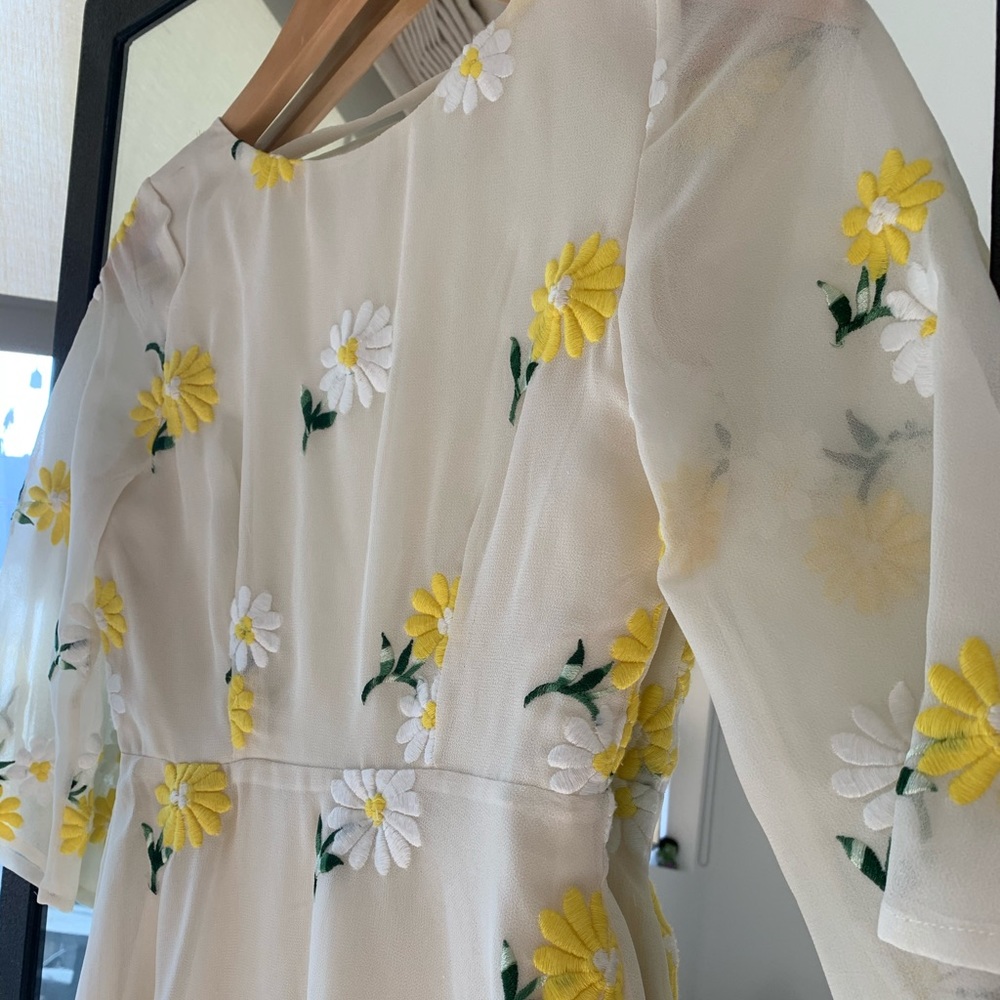 Cream colored shift dress with daisy embroidery.